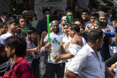 Bangladesh protesters, vowing to ‘guard revolution’, beat Hasina supporters