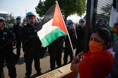 Pro-Palestine protesters tear down fence at Democratic convention center as thousands take to Chicago streets