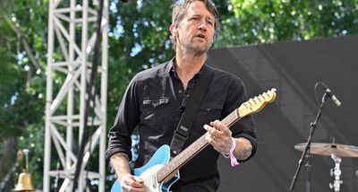 “I mean, that is like so illegal in the Foo Fighters but I’ve slipped it in just a little bit without asking!”: Chris Shiflett says Richie Sambora inspired him to take a pink Superstrat on tour with the Foos, and now he’s divebombing in solos