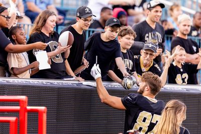 Foster Moreau signs a fan’s oyster shell at open practice