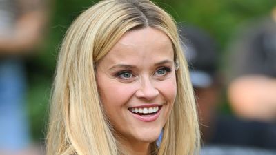 Reese Witherspoon's mustard cardigan and elegant gold jewellery prove how easy it is to make bright hues more wearable