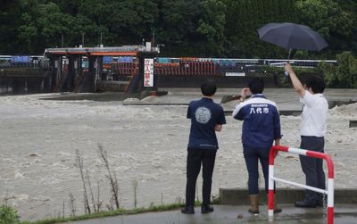 Slow tropical storm dumps heavy rain around Tokyo after causing floods in southern Japan