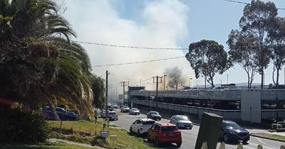 Customers evacuated after grass fire breaks out on land near Aldi