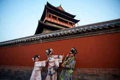 AP PHOTOS: Beijing's imperial palace bustles with throngs of visitors in Qing dynasty costumes