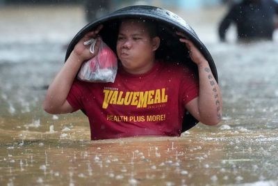 Fierce storm blows out of northern Philippines after leaving 14 dead in landslides and floods