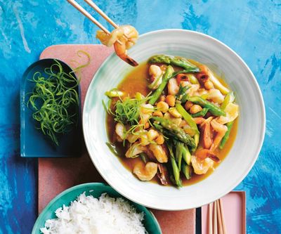 Speedy, silky and saucy: Alice Zaslavsky’s prawn, macadamia and asparagus stir-fry – recipe