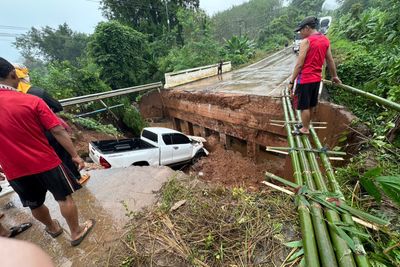 Truck drives off washed-out bridge during storm