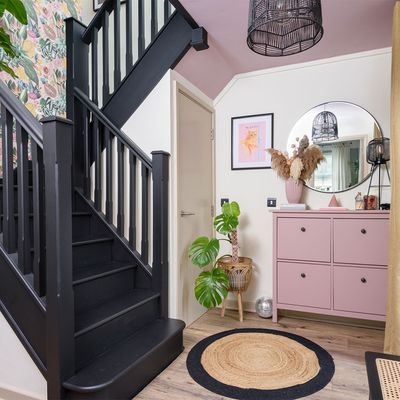 Painting the staircase black has taken this renter's hallway from drab to fabulous