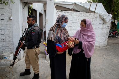 A roadside bomb hits a vehicle carrying police guarding an anti-polio drive in Pakistan, wounding 9