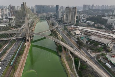 Smoke clouds Sao Paulo's skies and the Pinheiros River turns emerald green amid fire and drought