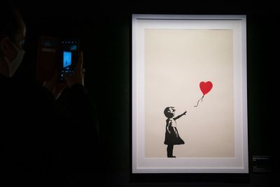 Two charged after famous Banksy painting stolen from London gallery