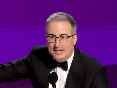 John Oliver curses as he’s played off at the Emmy’s while paying tribute to his dead dog