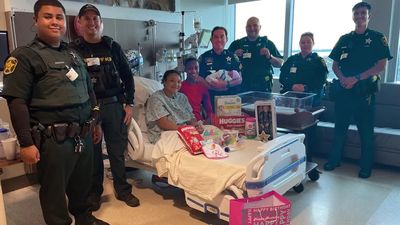 Woman gives birth in Florida police station parking lot, officers shower baby with gifts