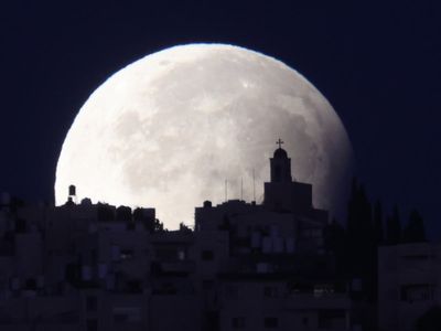 Stunning photos show rare partial lunar eclipse of supermoon which was spotted across UK skies