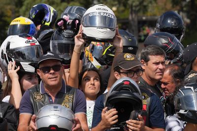 An estimated 180,000 motorcyclists converge at Portuguese shrine to have their helmets blessed.