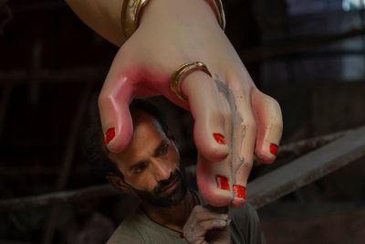 An AP photographer captures an artist working on an idol of Hindu god Ganesha ahead of festival