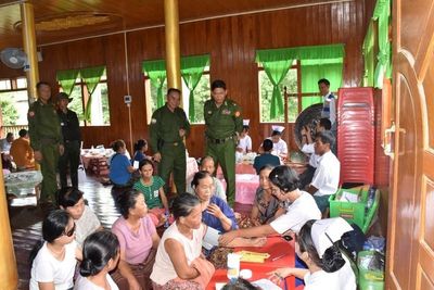 Myanmar soldiers help clean up after a typhoon that killed more than 380 people