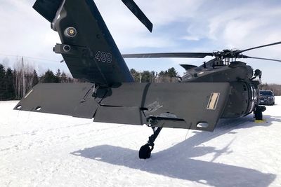 A snowmobiler who crashed into a parked Black Hawk helicopter is awarded $3 million