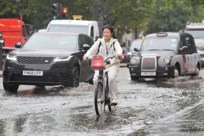 UK weather live: Commuters suffer delays due to heavy rain and flooding as new Met Office warning issued