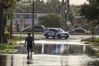 Rescuers Brave Floodwaters To Save Residents From Burning Home