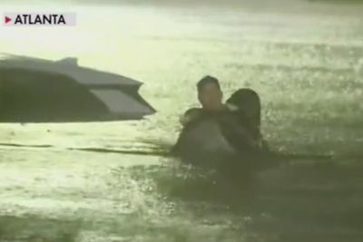 A TV reporter was doing a live hurricane report when he rescued a woman from a submerged car