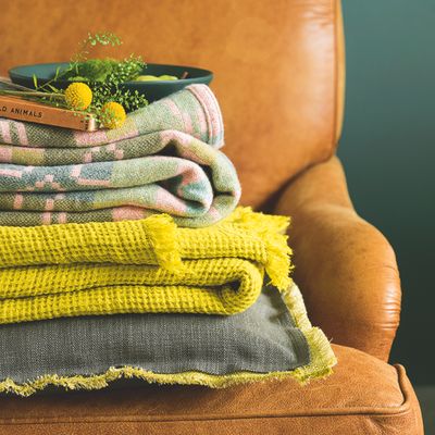 As an interior stylist, this is how I make blankets look chic in a living room - all the tricks of the trade