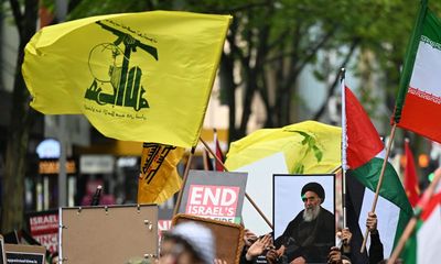 Woman, 19, charged after allegedly displaying Hezbollah flag at Sydney rally