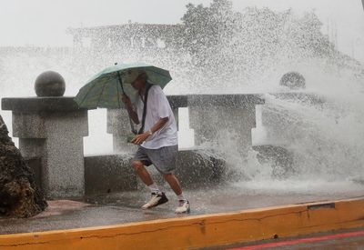 Typhoon bringing heavy rain slowly heads toward Taiwan, where 4,000 have evacuated