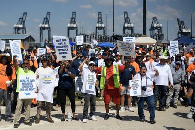 Longshoremen suspend strike, win raises