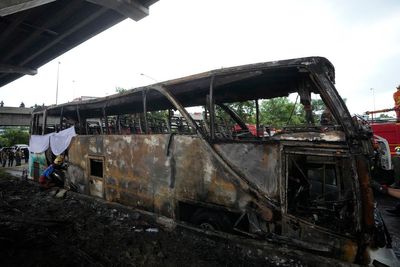 Operator of a Thai bus that caught fire and killed 23 is charged, as investigators suspect gas leak