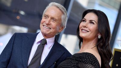 Catherine Zeta-Jones and Michael Douglas' living room combines bold wallpaper, gold accents, and period details for a modern twist on classic style