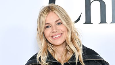 Sienna Miller oozes sophistication in denim midi dress and leather trench coat - her unique lace up boots complement the look beautifully