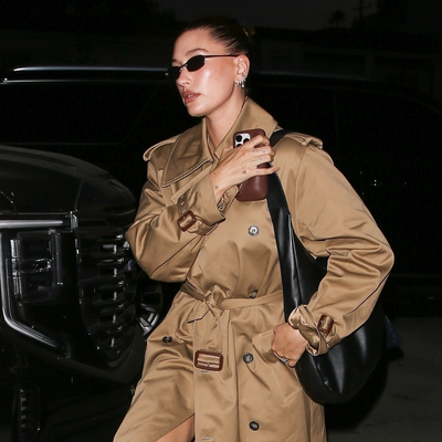 Hailey Bieber Remixes the Rich-Girl Fall Uniform in a Shiny Khaki Trench Coat and Blue Loafers