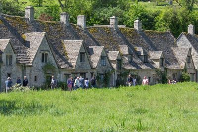 Tourists spotted climbing private walls and jumping fences in Cotswolds village to snap selfies