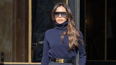 Victoria Beckham takes a cream midi skirt and jumper from simple to chic with burgundy platform knee high boots – it's the perfect mix of style and comfort