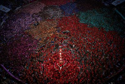 An AP photographer gets the light just right from a perch up high above a human tower competition