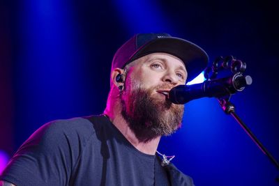 Country star Brantley Gilbert pauses concert as wife gives birth on tour bus – then returns to finish show