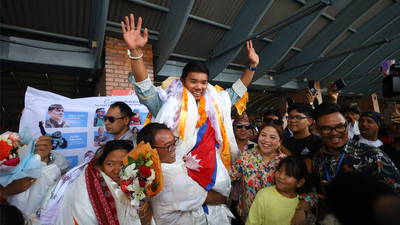 Record-breaking Nepalese teen returns home to hero's welcome after summiting Earth's tallest peaks