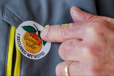 Georgia smashes records on first day of early voting as GOP hand-counting rule blocked by judge