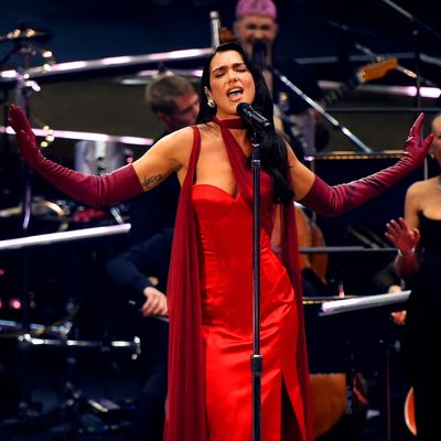 Dua Lipa Pours Herself Into a Cherry Red Corset Gown With a Sweeping Merlot Cape at Her Intimate London Concert