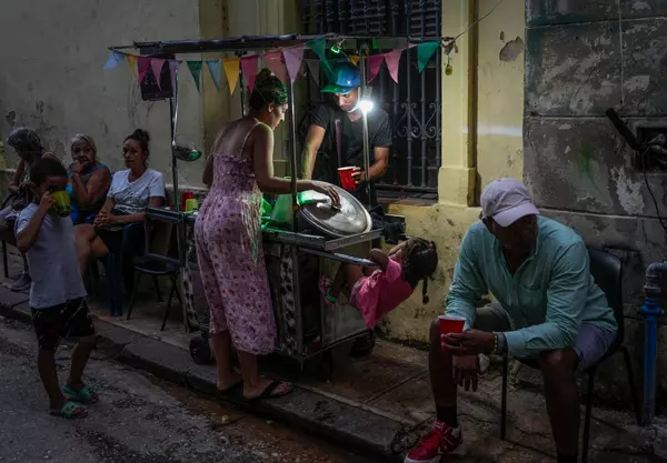 Cuba fights to come back from a nationwide blackout, then a storm that killed six