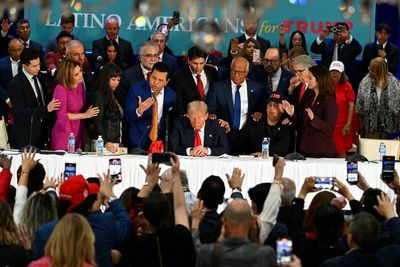 Latino voters lay hands and pray for Trump as they shower him with religious gifts during Miami visit