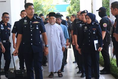 Malaysia charges 22 members of an Islamic business group, including its CEO, for organized crime