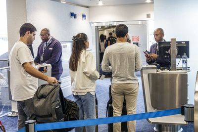 American Airlines is testing a new system to humiliate 'gate lice,' the people who try to board planes before their seating group is called