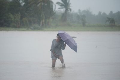 Deadly storm blows away from northern Philippines, but forecasters warn it may do a U-turn