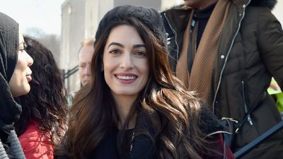 Amal Clooney layers up against the cold in cosy tartan jacket, leather trousers and chic biker boots - we're taking style notes on her beanie too