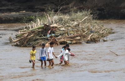 More than 120 die in Tropical Storm Trami in the Philippines with Vietnam braced for destruction