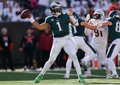 Jalen Hurts completes pass with one green and one white cleat