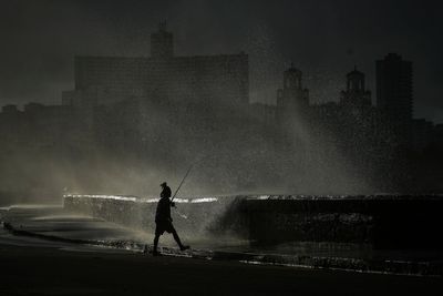 In storm and blackout, an AP photographer finds a fisherman in a sliver of natural light