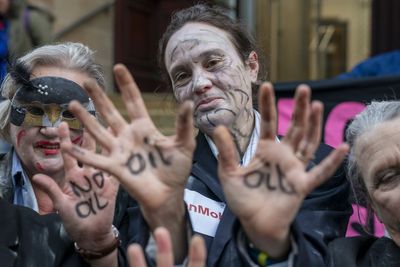 Climate activists in ‘zombie dance’ protest outside insurance offices